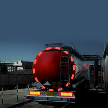 Red Conspicuity Tape (Rigid Grade - Segmented for Tankers) - 50 Metre Roll, shown on a red tanker trailer, enhances visibility and safety for commercial vehicles.