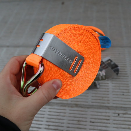 Dynello 35mm Strap Clip (6 pack), stainless steel, shown in hand holding a coiled strap, ideal for organizing and preventing strap tangling.