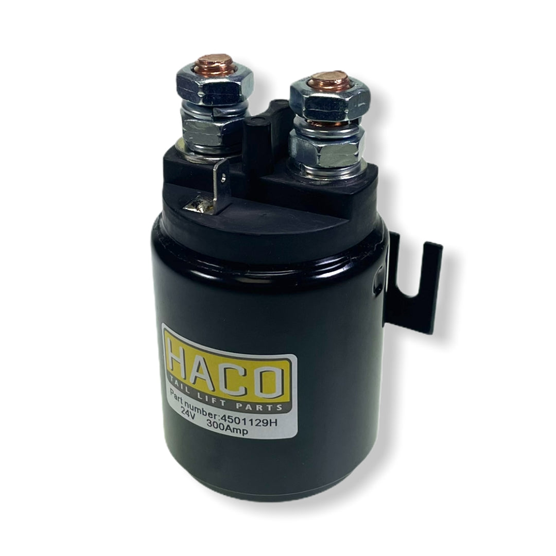 Starter Solenoid 24V 300 AMP by Haco, featuring a black cylindrical design with metal bolts and a white label. Ideal for large commercial trailers.